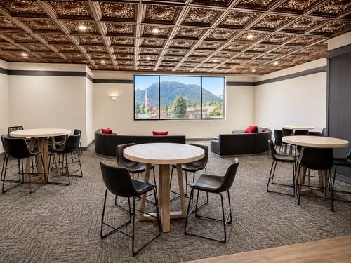 Meeting space at Expedition Lodge Estes Park with tables, seating, and mountain-themed decor.