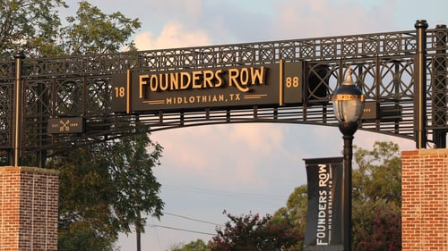 Archway over the parking lot entrance at Founders Row
