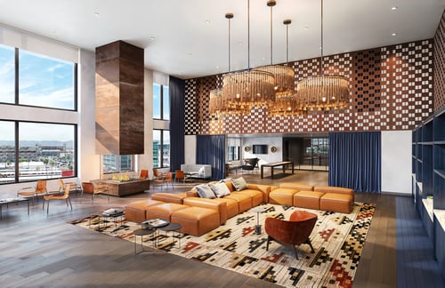 Large clubroom with sectional sofa, tall ceilings, and patterned feature wall.