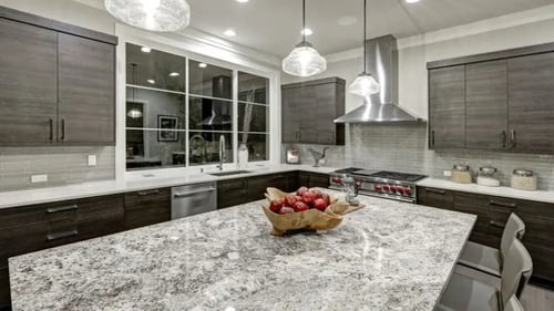 brown kitchen with gray and white granite