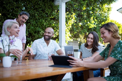 Group of friends sitting at a table outside