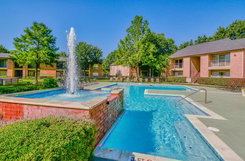 Resort-style pool with fountain at Creekside at Pear Ridge Apartments, Texas