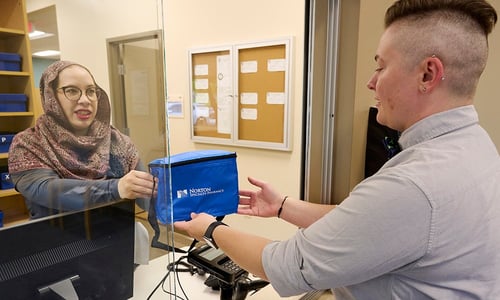 A woman picks up a specialty pharmacy order