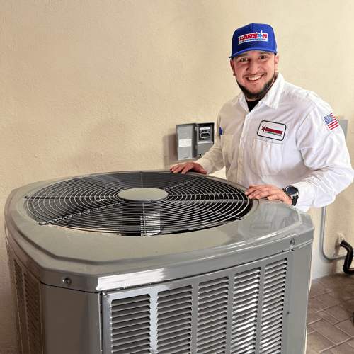 Technician standing in front of heat pump