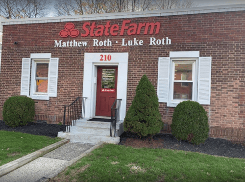 Brick building with red State Farm sign