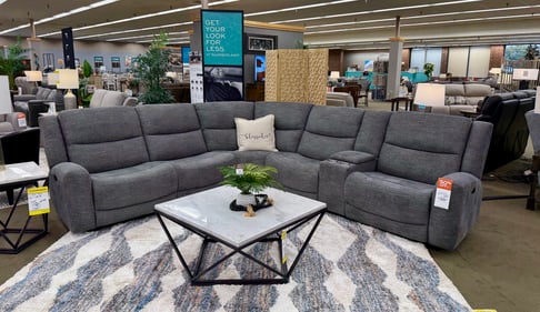 Gray fabric power reclining sectional with geometric marble-top tables on display at Slumberland Furniture Burlington. Explore stylish, comfortable sectionals in Burlington, Iowa.
