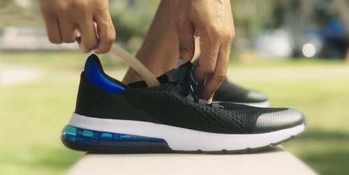 athlete placing arch support in shoe