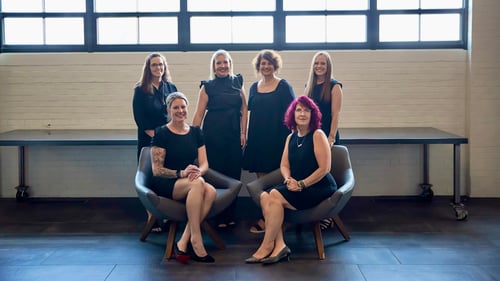 Six women team members of the Christel Manson State Farm Insurance agency posing for a group photo.