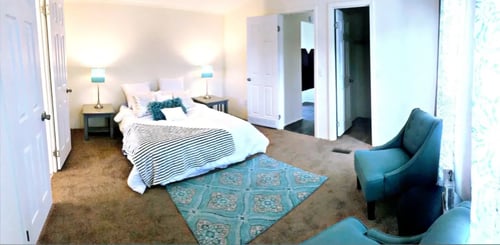 a bedroom with a bed and a chair