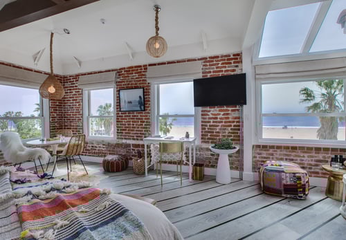 Interior view of a stylish Venice Beach hotel suite, showcasing a stunning Pacific Ocean view.