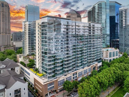 modern high-rise apartment building exterior at sixty 11th in midtown atlanta with city skyline views