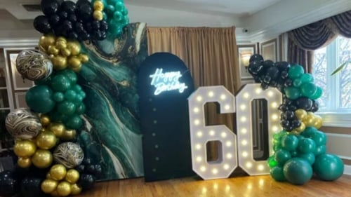 Green and gold birthday display with large light up numbrs
