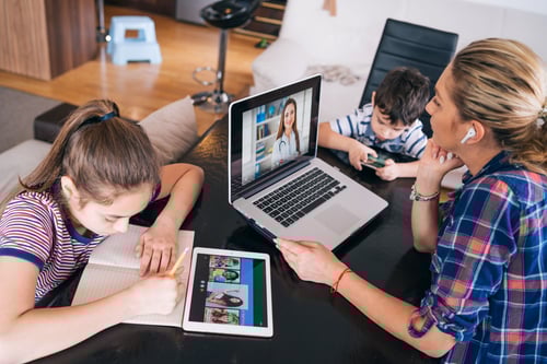 Mom and kids interacting with multiple devices at home