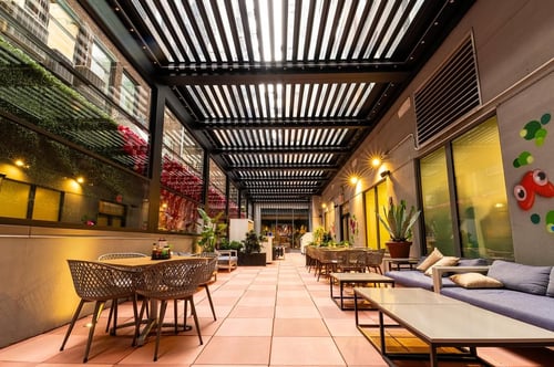 Venue at El Lugar with tables, chairs, lights.