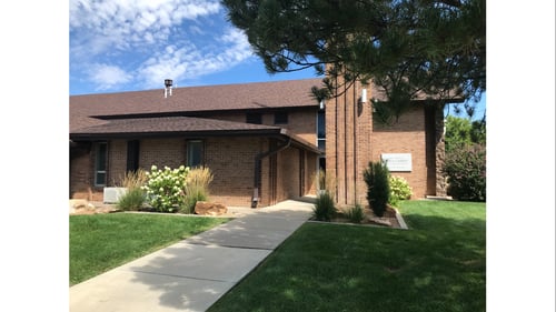 Brown-red brick building with brown roof