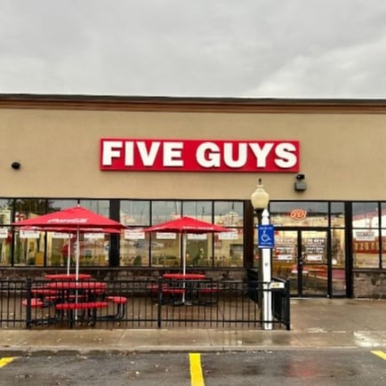 Exterior photograph of the entrance to the Five Guys restaurant at 1290 Arsenal Road in Watertown New York.