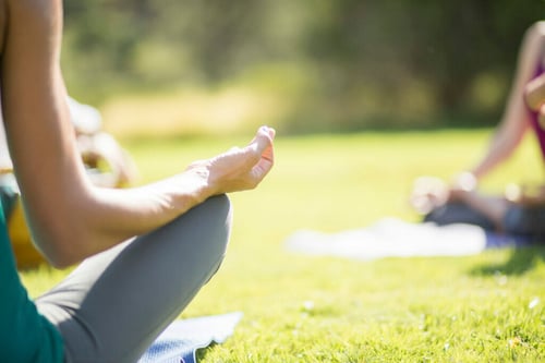 Group yoga outside at Mii Amo