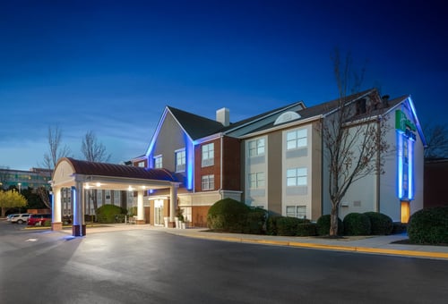Hotel lobby with warm lighting and seating area in Alpharetta