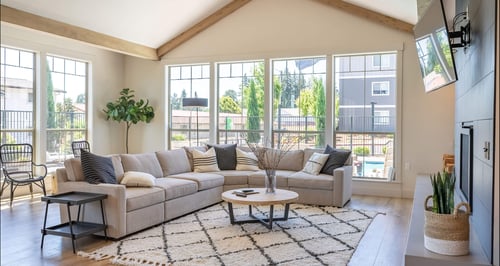 A living room with a couch, a coffee table, and a TV at St Helens Place Apartment Homes, Oregon