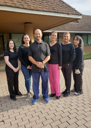 Team members of Brenner Dental Group of Southampton PA standing outside their office entrance