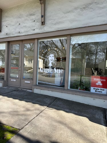 White building with brown trim and red State Farm sign
