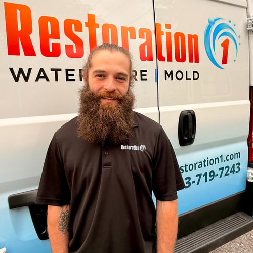 Owner of Restoration 1 of Chattanooga standing in front of emergency van.