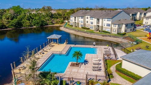 Apartment complex with pool at Retreat at Valencia Apartment Homes, Orlando, FL