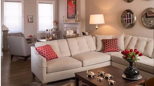 white sectional sofa with orange pillows
