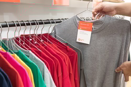 Multiple t-shirt styles on a clothing rack