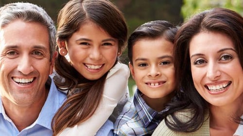 man, woman, girl and boy smiling