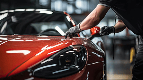 Auto body repair technician working on car