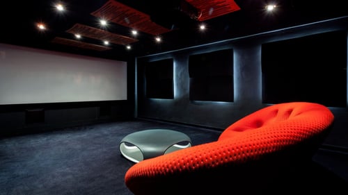 projector screen with an orange sofa