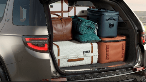 Open boot of a Discovery packed with luggage and travel gear.