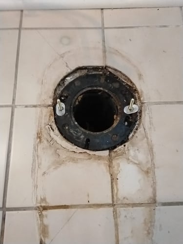 an exposed closet flange for a toilet in a pre war Southeast Portland home.