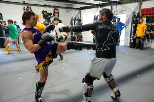 Photo of two Muay Thai students sparring at McMahon Training Center