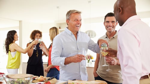 Group of men and women at a party mingling