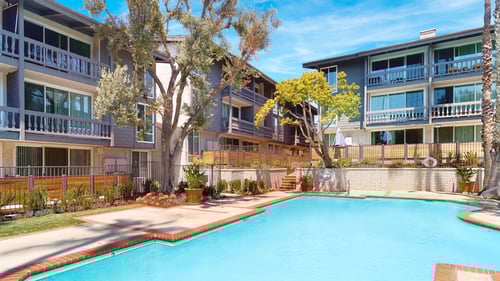 A swimming pool in front of apartment buildings at The Meadows Apartments, Culver City , CA 90230
