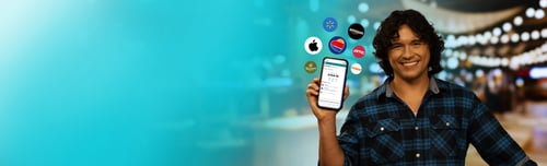 Spencer holding phone with app icons