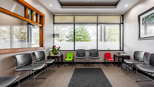 Interior of Gentle Dental Newberg showing a waiting area with chairs and a television for patient entertainment.