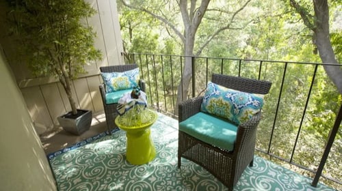 Model Apartment patio with wicker chairs and a table at Abby Creek Apartments, Carmichael, CA, 95608