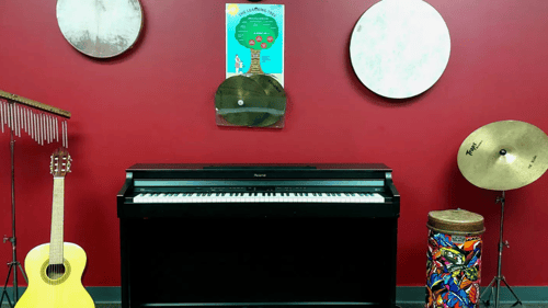 various musical instruments set against a red wall