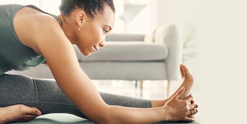 woman stretching her feet in living room