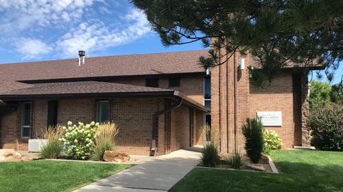 Brown-red brick building with brown roof