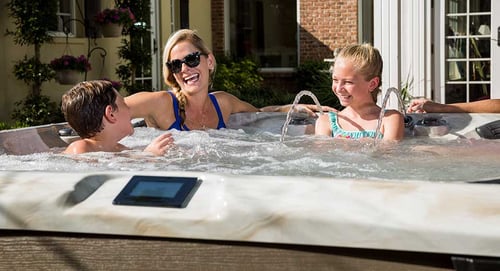 Valley Pool & Spa hot tub with a mother and two children enjoying time together in the water