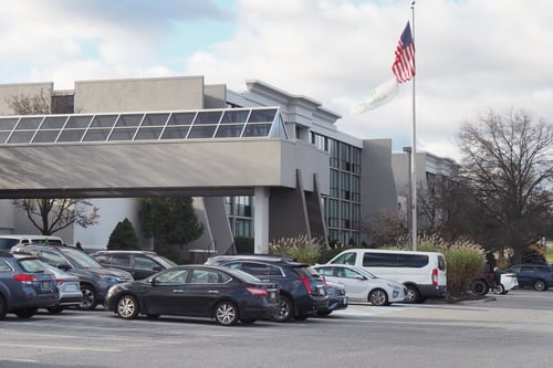 Hotel exterior in Harrisburg with parking lot and entrance canopy.