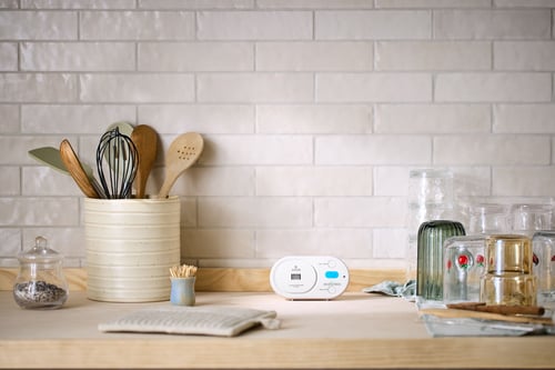 A Carbon Monoxide Alarm sits on a kitchen counter