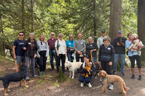 The team members of Eydt Wealth Partners hiking with their dogs.