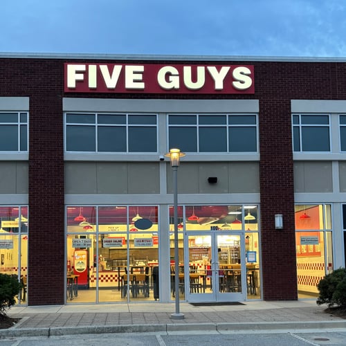 Exterior photograph of the Five Guys restaurant at 2622 Holcomb Bridge Road in Alpharetta Georgia.