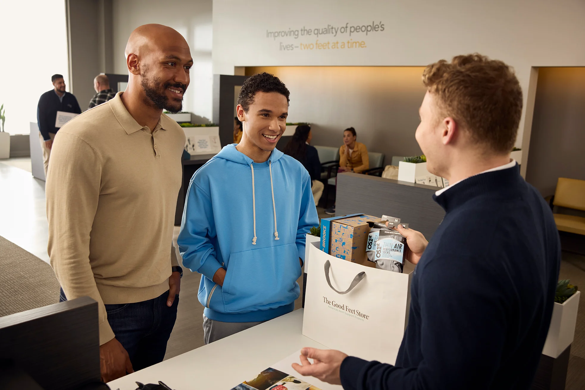 Father and son getting custom arch support at The Good Feet Store