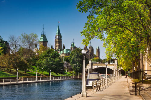 the ottawa canal with the parliament buildings in the background.